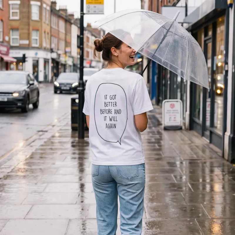"it got better before and it will again" Backprint Tee worn by a model