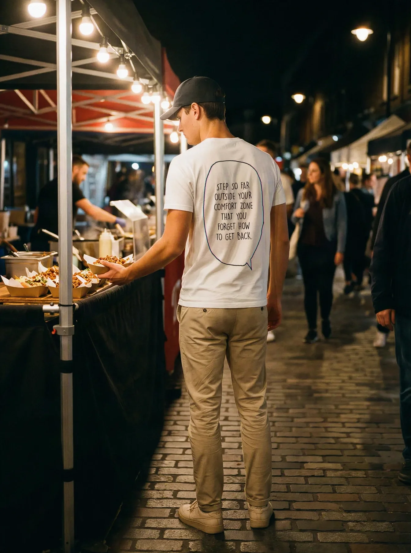 "Step outside your comfort zone & forget how to get back." Backprint Tee worn by a model