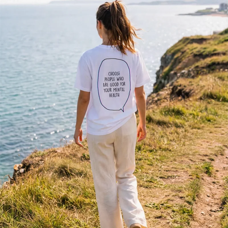 "Choose people who are good for your mental health" Backprint Tee worn by a model
