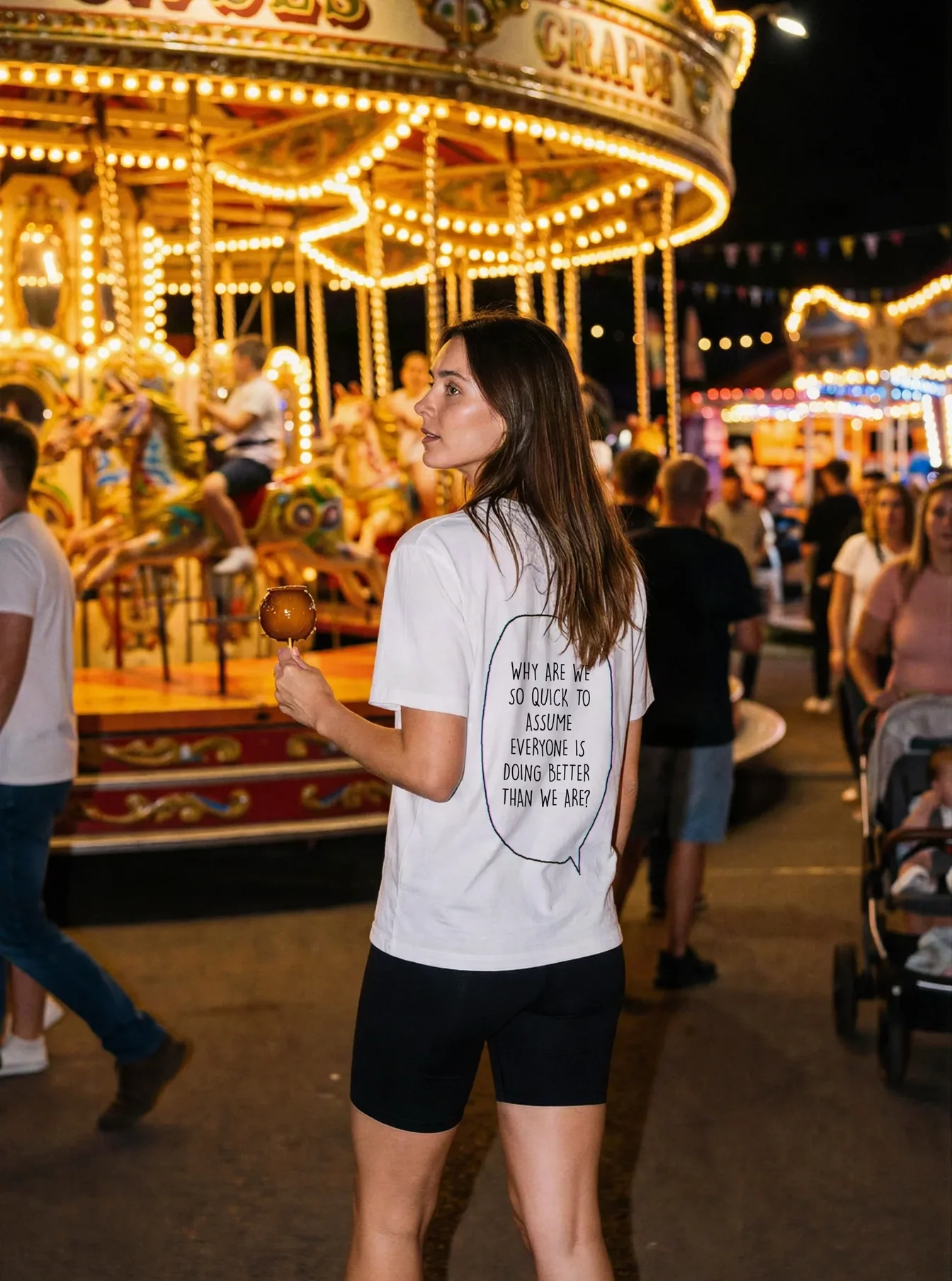 "WHY ARE WE SO QUICK TO ASSUME EVERYONE IS DOING BETTER THAN WE ARE?" Backprint Tee worn by a model