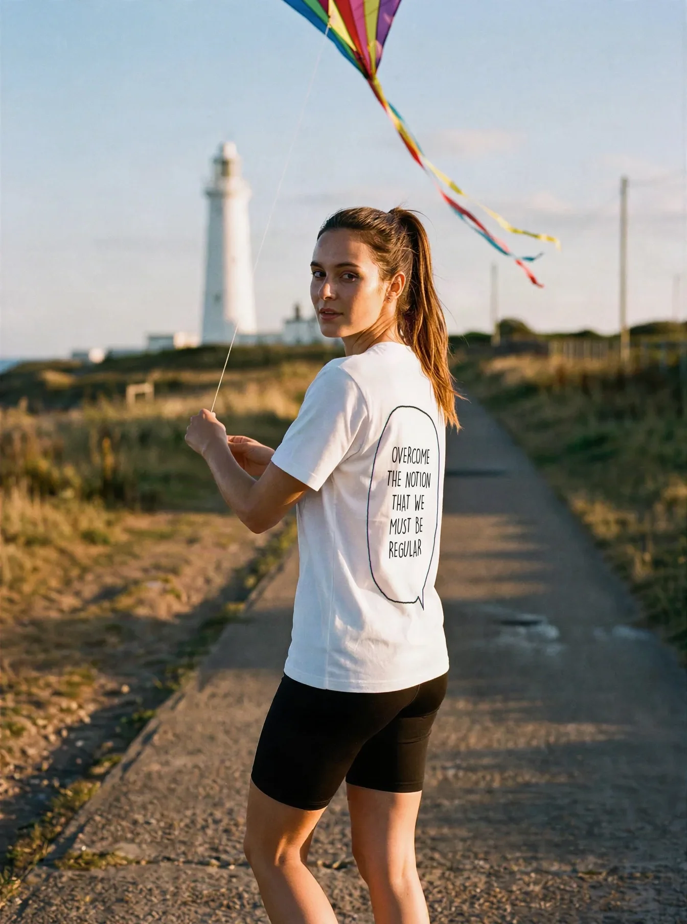 "Overcome the notion that we must be regular" Backprint Tee worn by a model