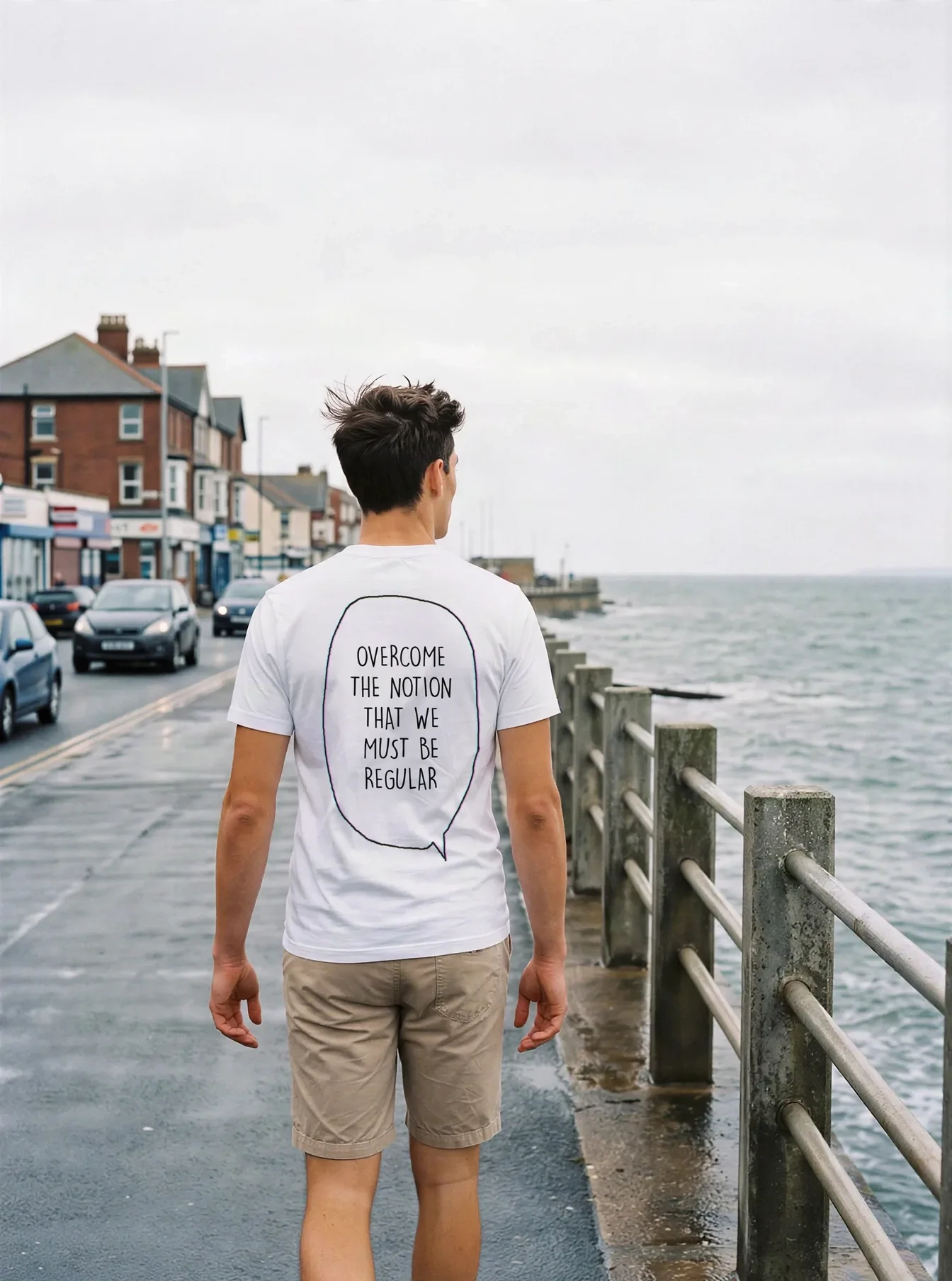 "Overcome the notion that we must be regular" Backprint Tee worn by a model