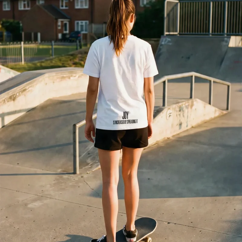 "JOY IS INCREASED BY SPREADING IT" Backprint Tee worn by a model