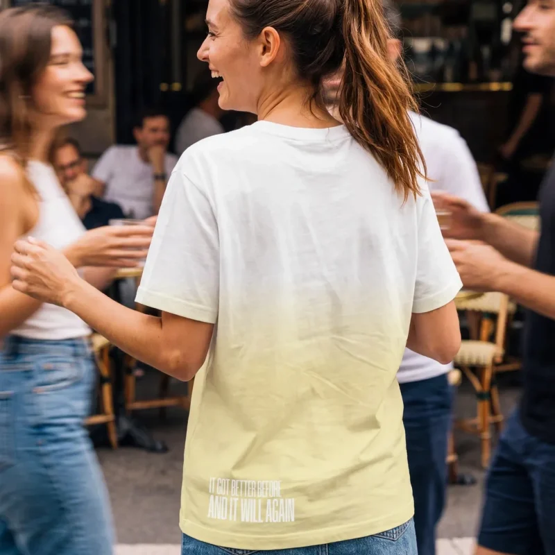 "it got better before and it will again" Backprint Tee worn by a model