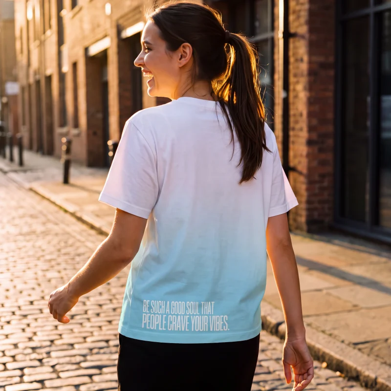 "Be such a good soul that people crave your vibes." Backprint Tee worn by a model