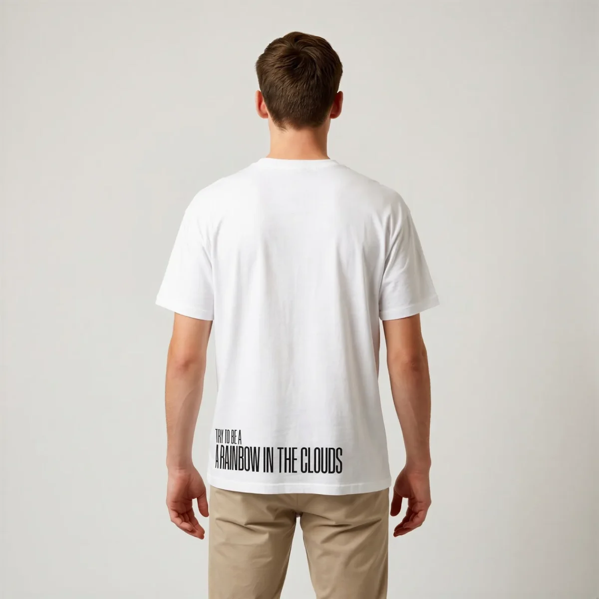 "Try to be a rainbow in the clouds" Backprint Tee, back view, Its.That.