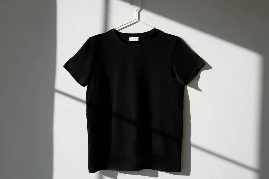 Collection of oversized t-shirts displayed on hangers showing various streetwear design styles including minimalist logos and bold graphic prints